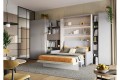 Półkotapczan BED CONCEPT  z tapicerowanym zagłówkiem i sofą.